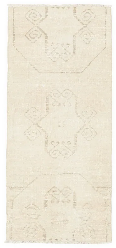 Full top view of the 2'7" x 6'1" ivory geometric vintage Anatolian runner on a white background