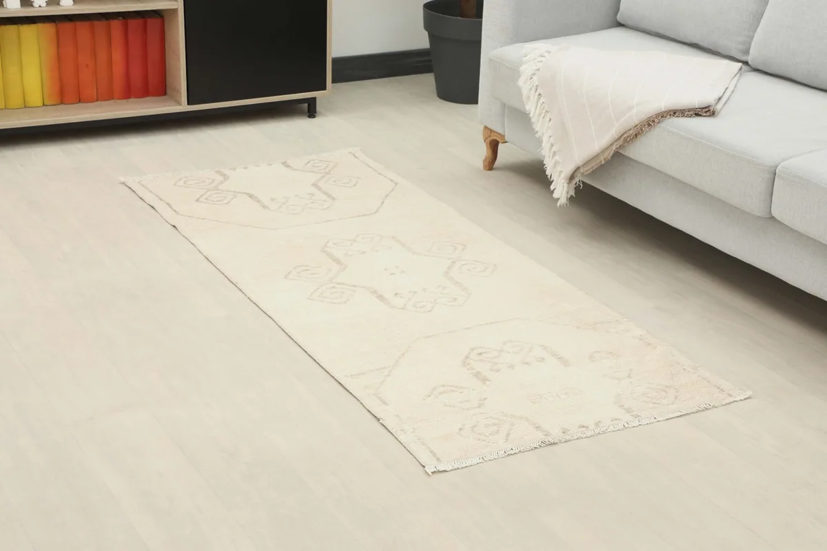 Overhead view of the ivory runner placed in a modern living room beside a sofa and cabinet
