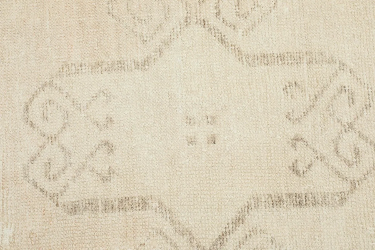Macro view of the subtle geometric patterns and the low pile of the vintage Anatolian runner