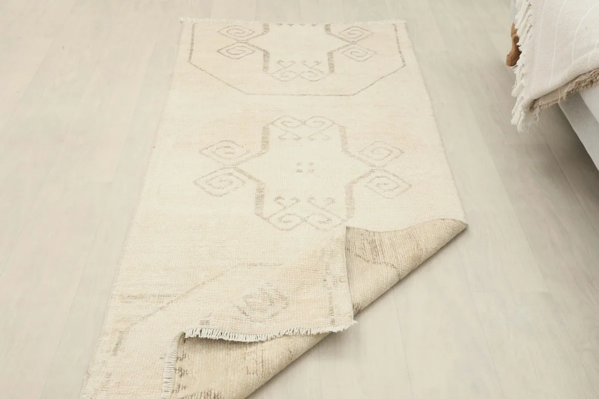 The ivory runner with one end folded back, displaying the underside and overall length