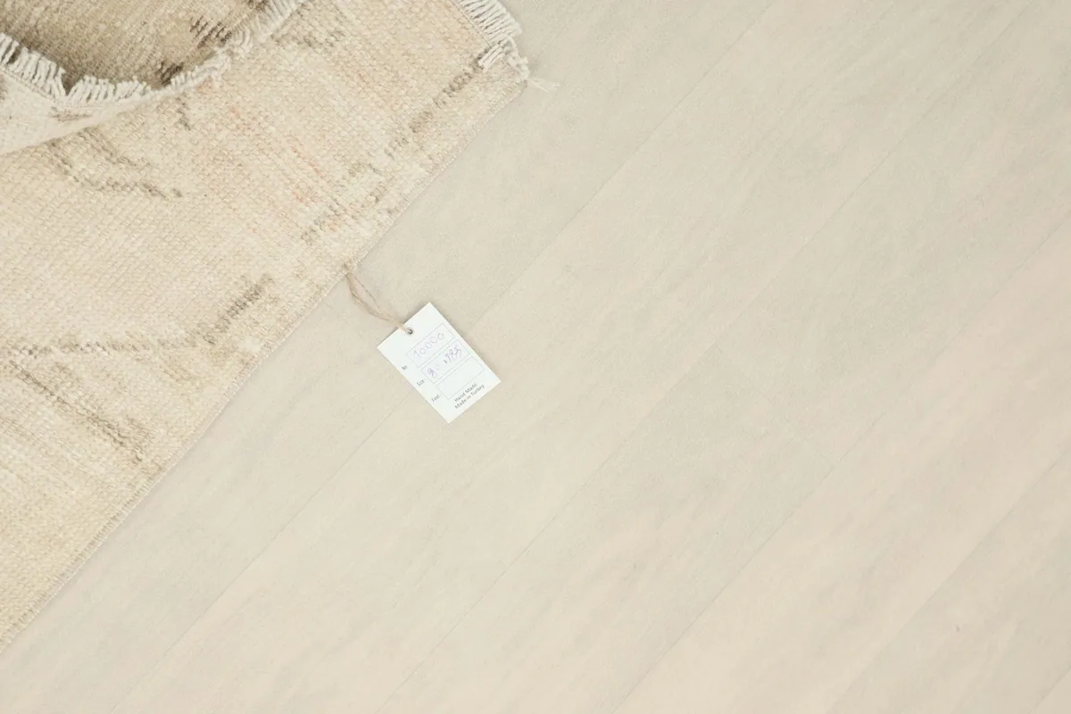 Overhead view of a corner of the runner with a product tag, showing the texture and color