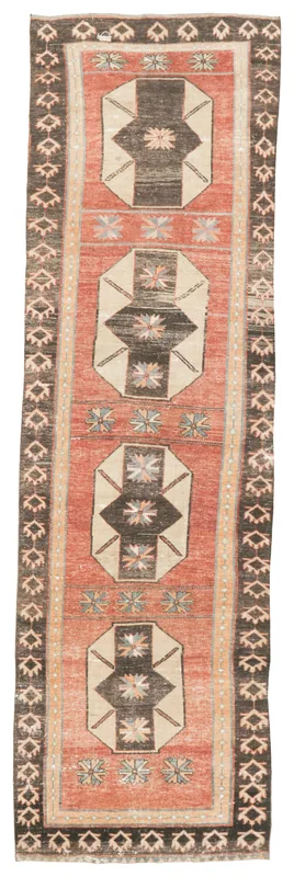 Full top view of the vintage rust, beige, and black Anatolian runner rug with geometric patterns