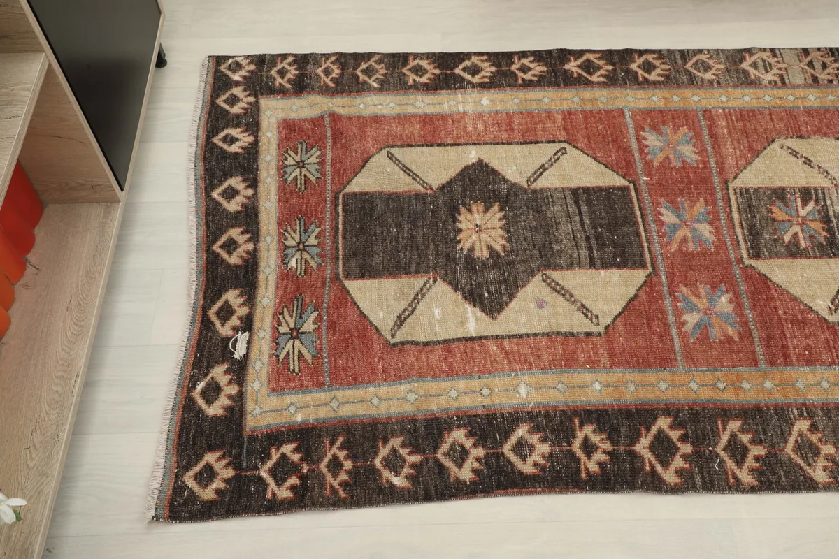 Angled view highlighting the central geometric medallion and the surrounding rust field