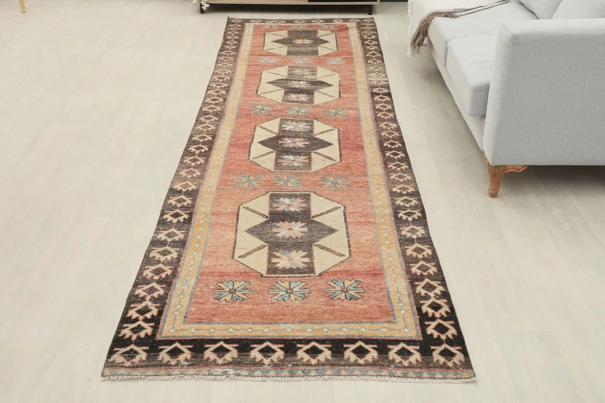 Full view of the rust runner rug laid out in a room, providing a sense of its scale and design