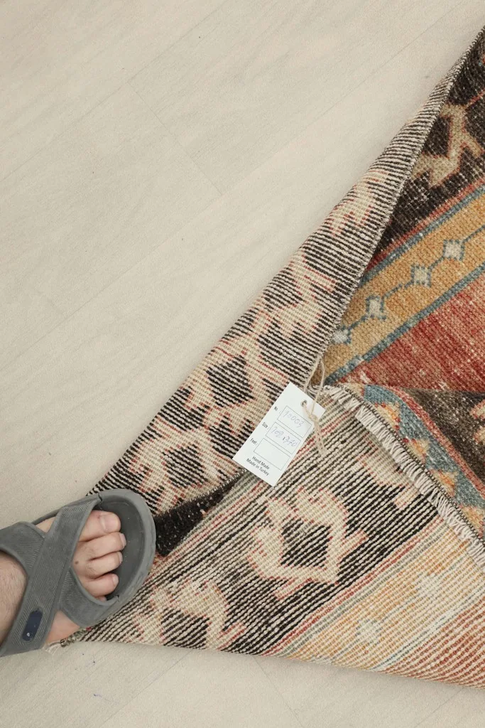 Close-up of the rug's underside, showing the hand-knotted cotton foundation and wool pile