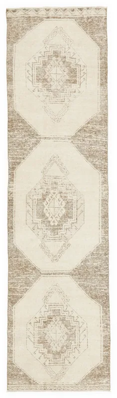 Full overhead view of the beige and brown geometric runner rug on a white background