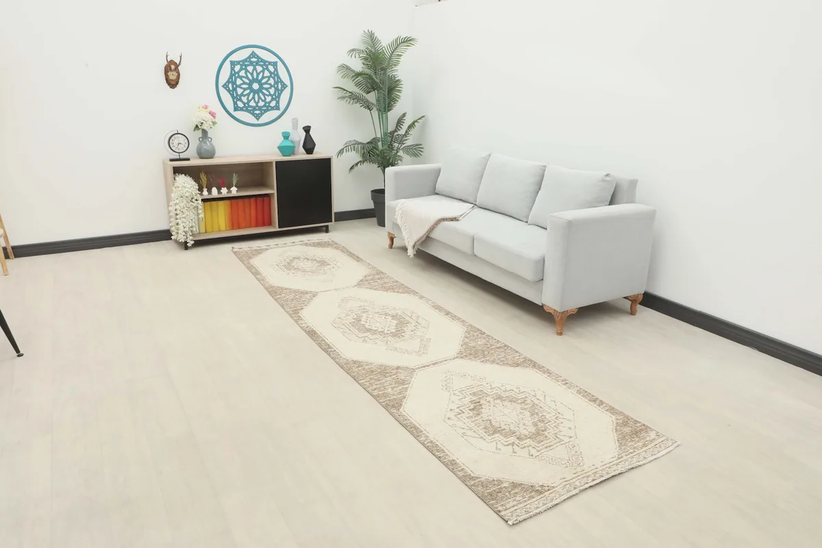 Vintage runner rug in a modern living space with a light gray sofa and minimalist decor