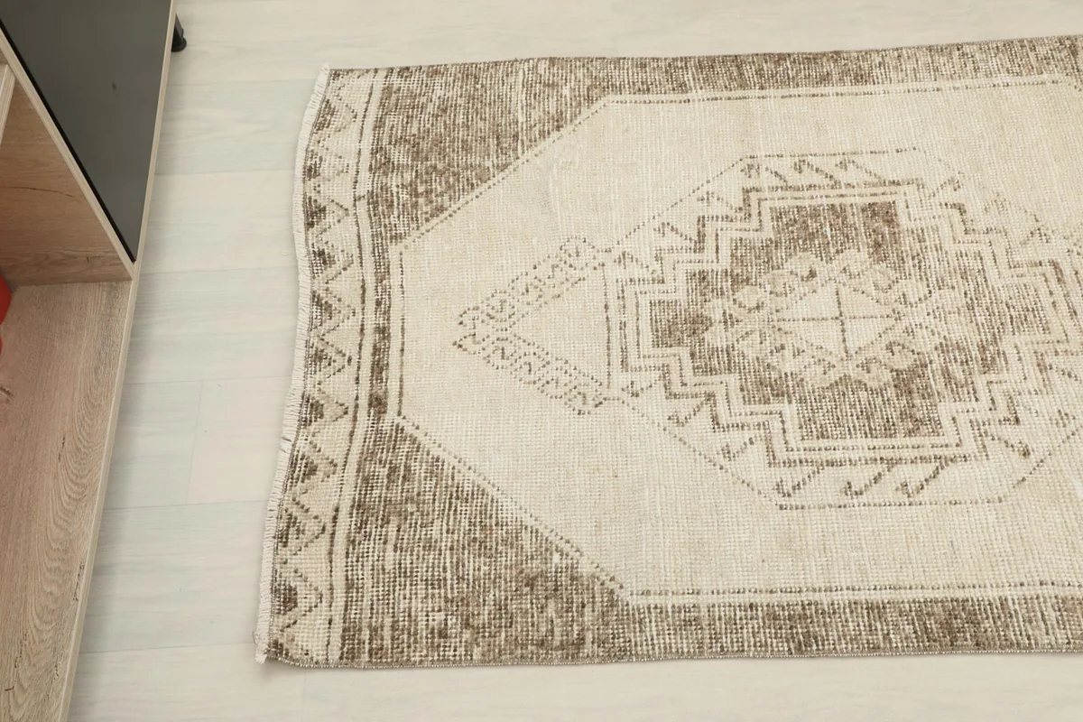 Corner detail of the runner rug, showing the border pattern and a subtle fringe