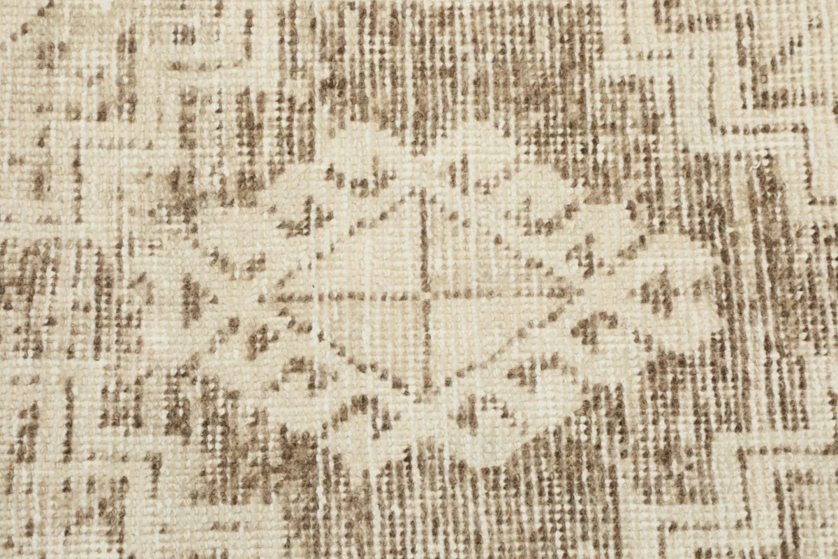 Texture of the low wool pile, showing the subtle variations in the beige and brown colors