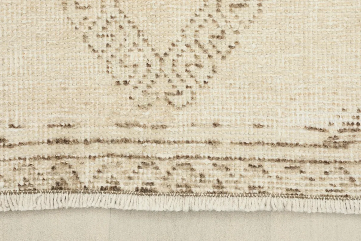 Close-up of the short, natural fringe and the woven edge of the runner rug