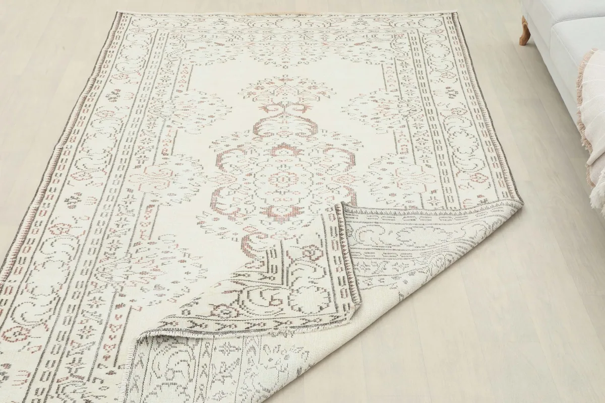 Partial view of the rug's back, showing the hand-knotted construction and the evenness of the weave.
