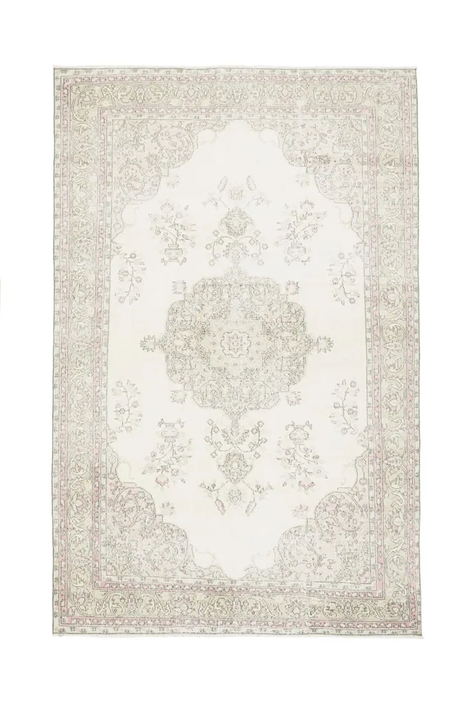 Overhead view of the ivory and pink vintage rug, showing its full design