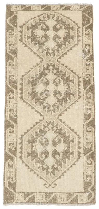 Full top view of the beige and brown geometric Anatolian runner on a white background