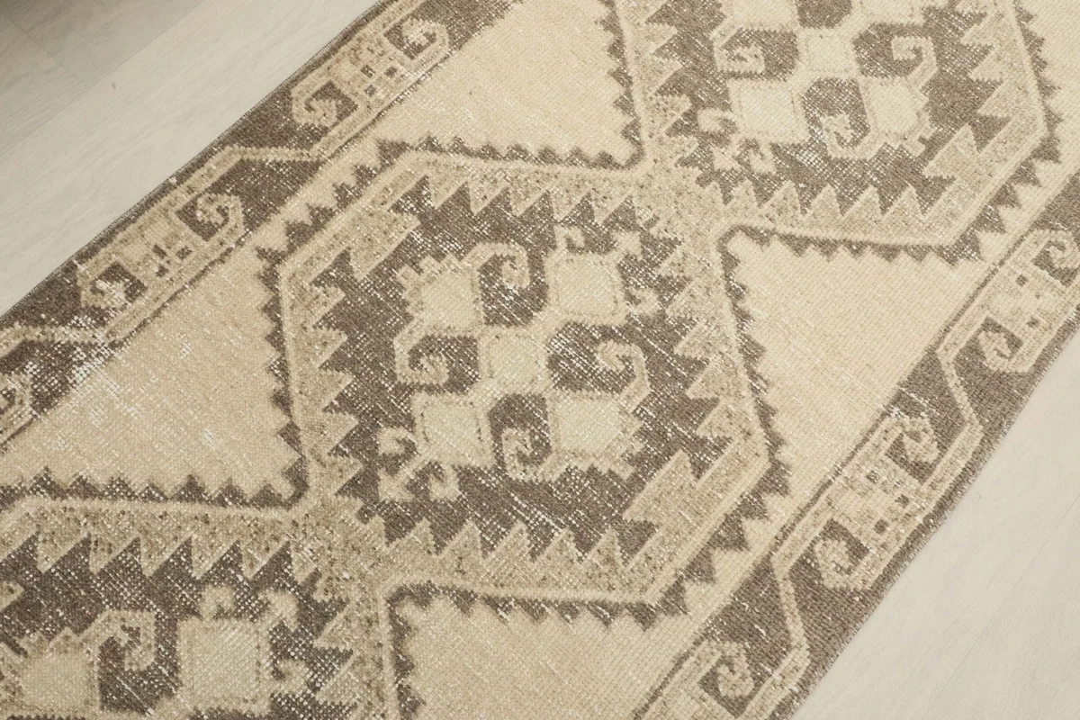 Overhead detail of the central geometric medallion and surrounding tribal patterns