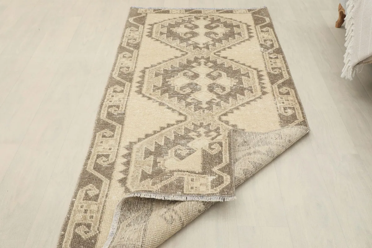 Partial view of the back of the rug, illustrating the hand-knotted construction and foundation