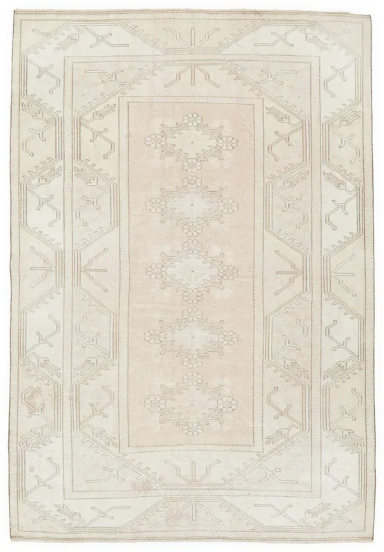 Full overhead view of the beige and rose vintage Anatolian rug with floral and geometric patterns