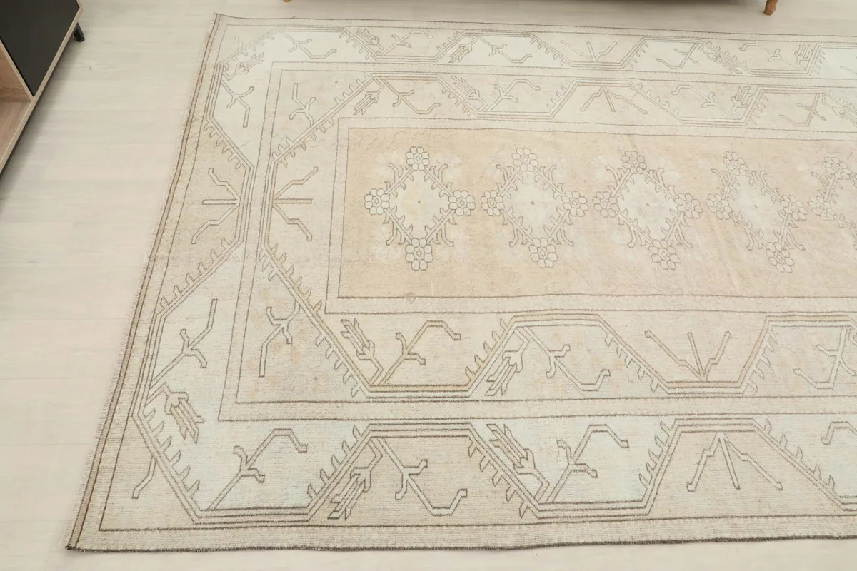 Another angled perspective of the rug, showing the blend of beige, rose, and cream tones