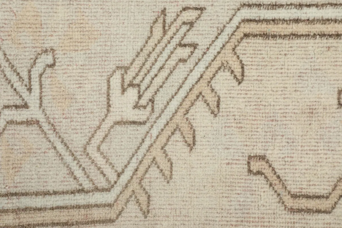 Close-up of the geometric patterns and distressed texture in the beige border area