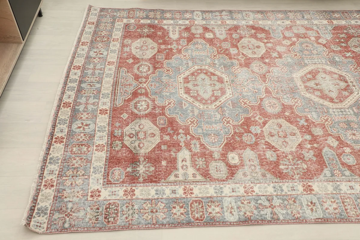 Angled shot of the rug's surface, capturing its texture and muted colors