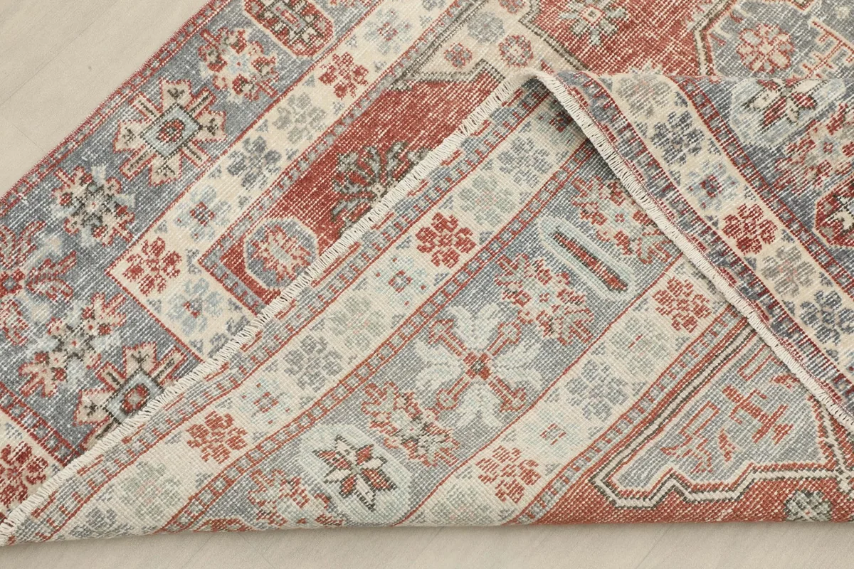Folded corner of the rug showing the reverse side and knotting detail