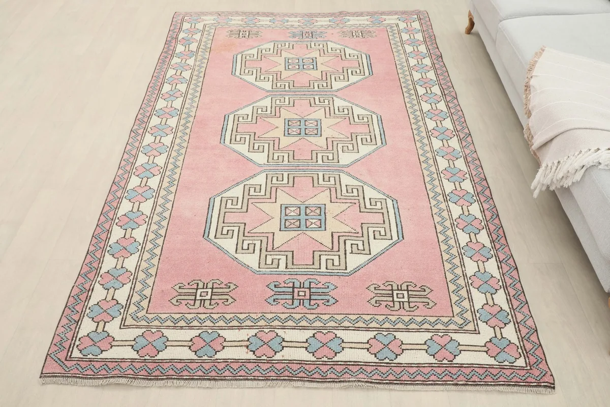 Overhead view of the pink geometric rug in a room, providing a sense of scale with a sofa