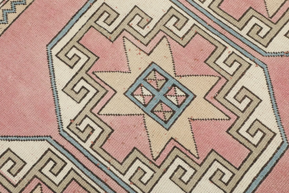 Detailed view of a central geometric medallion with star and Greek key patterns