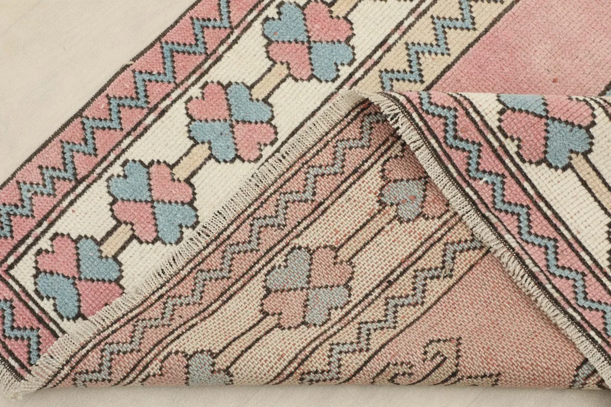 Folded section of the rug showing the reverse side and the hand-knotted construction