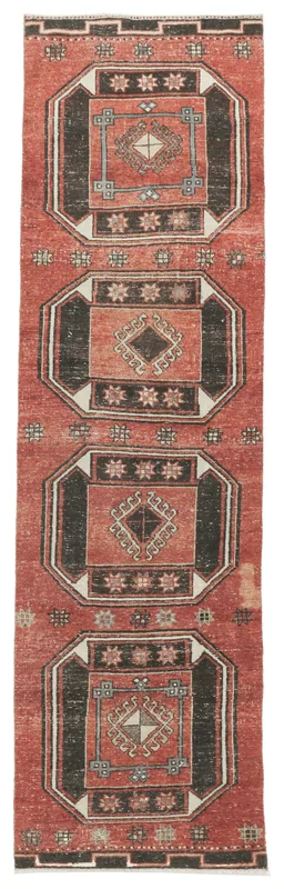 Full top view of the 3x11 rust and black geometric vintage Anatolian runner rug on a white background.