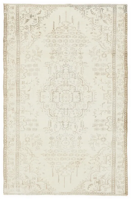 Full overhead view of the 5'2" x 8'9" cream and tan vintage Anatolian area rug on a white background.