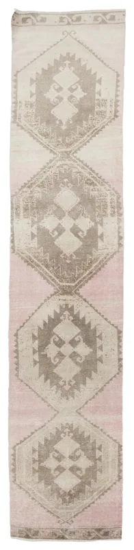 Full top view of the 2'9" x 14'5" vintage rose and beige geometric Anatolian runner on a white background.