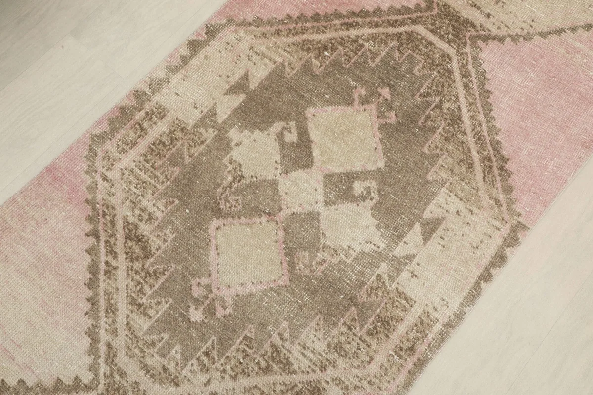 Detailed view of the central geometric motif, showcasing the intricate tribal patterns and distressed texture.