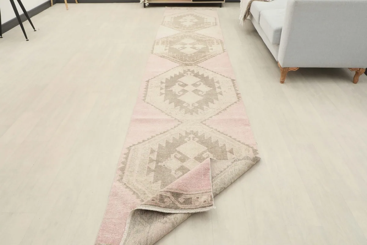 Runner rug partially folded, displaying its flexibility and showing the full length in a room setting.