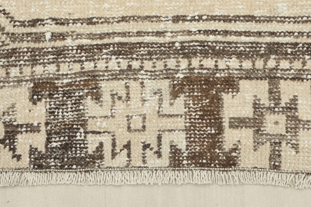 Close-up of the patterned border and short fringe on the end of the Anatolian runner rug.