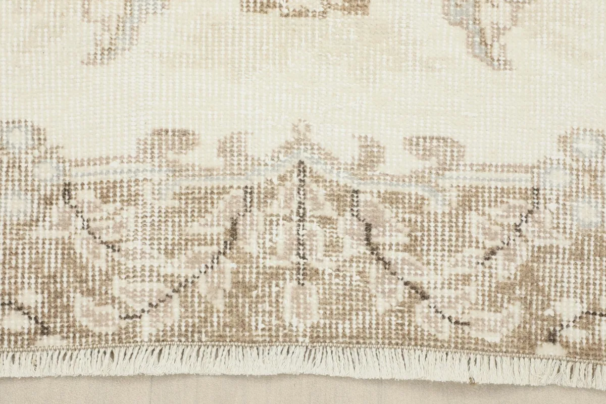 Close-up of the rug's border design and short, hand-finished fringe