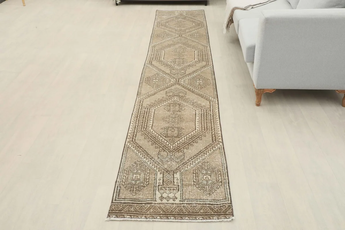 Full view of the runner rug laid out in a room, offering a perspective of its size and design.