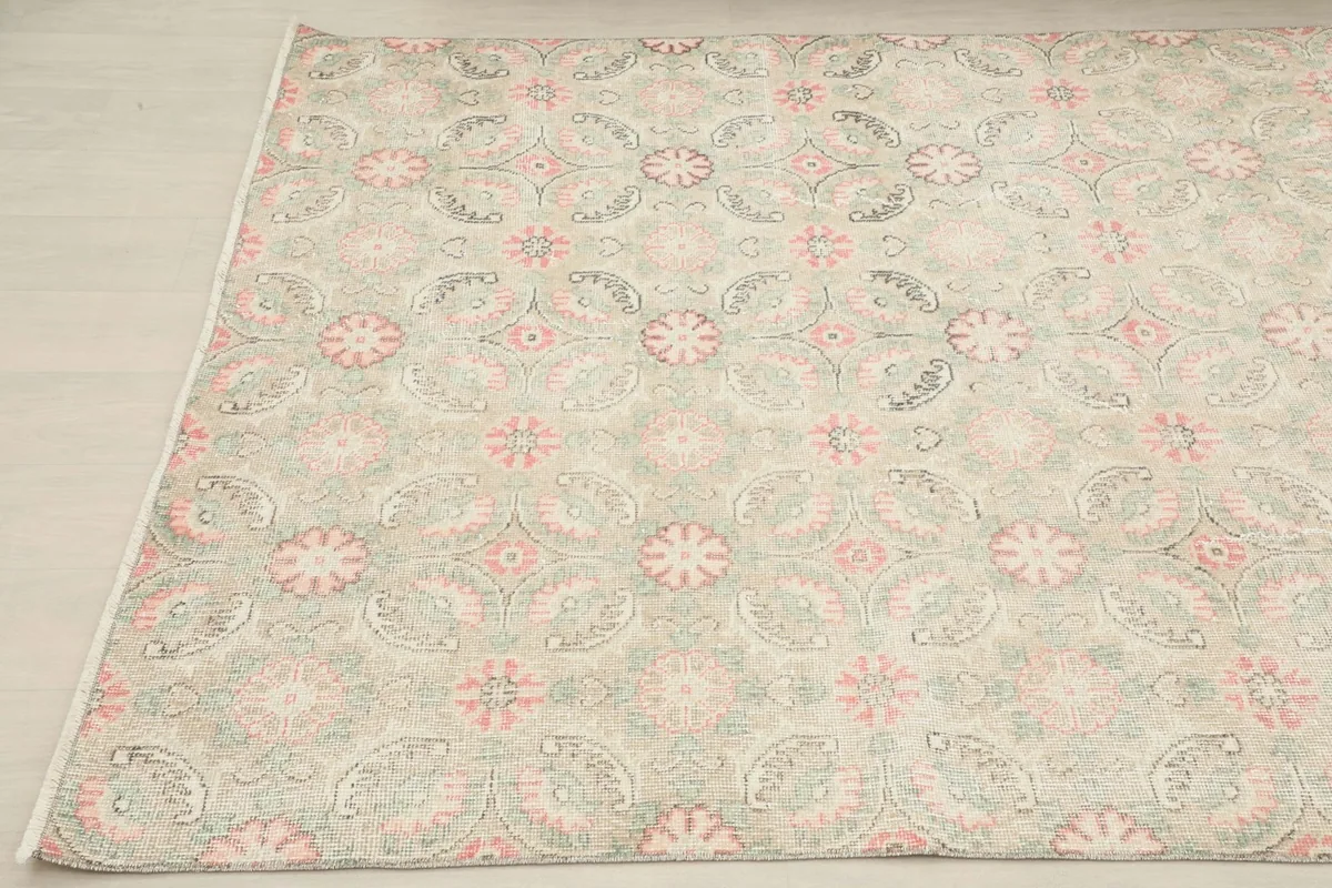 Another angled perspective of the vintage rug, showing the full pattern from a different side.
