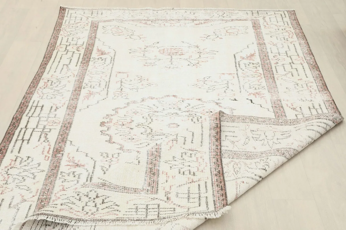 Angled view of the rug with a corner folded to show the thickness and construction