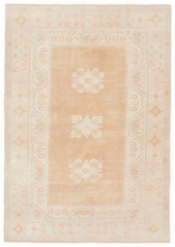 Full top view of the beige floral geometric vintage Anatolian rug on a white background