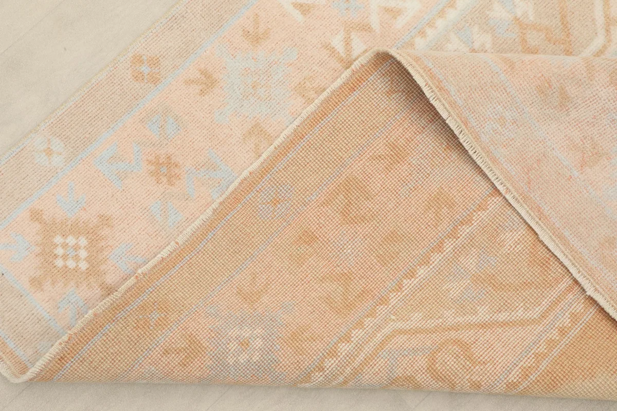 View of the rug's cotton foundation and the reverse side of the hand-knotted construction