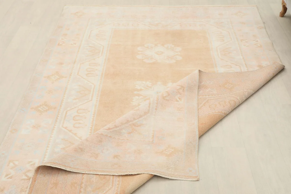 The rug partially folded back, showing the thickness and the reverse side