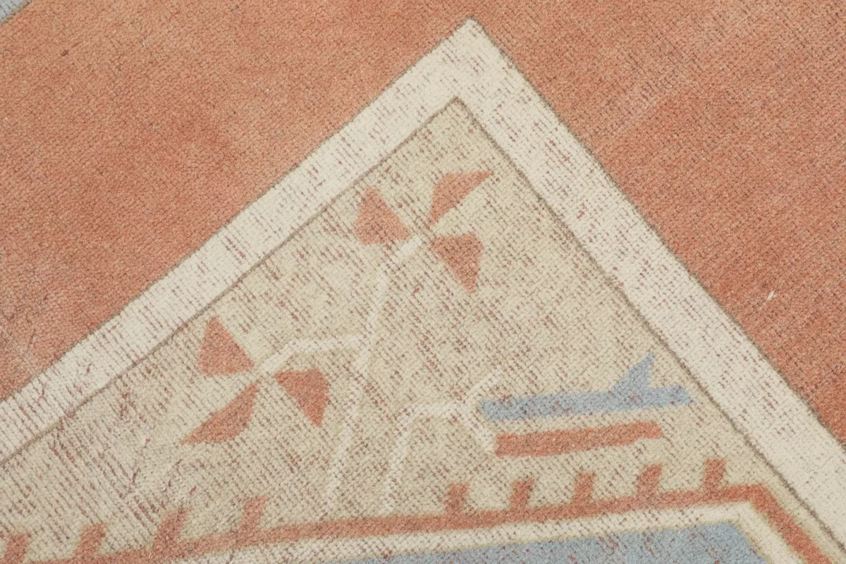 Detail of a corner of the rug's central panel, showing intricate geometric elements