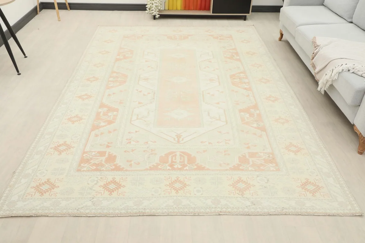 Full room view of the large ivory and orange rug, showcasing its scale and presence