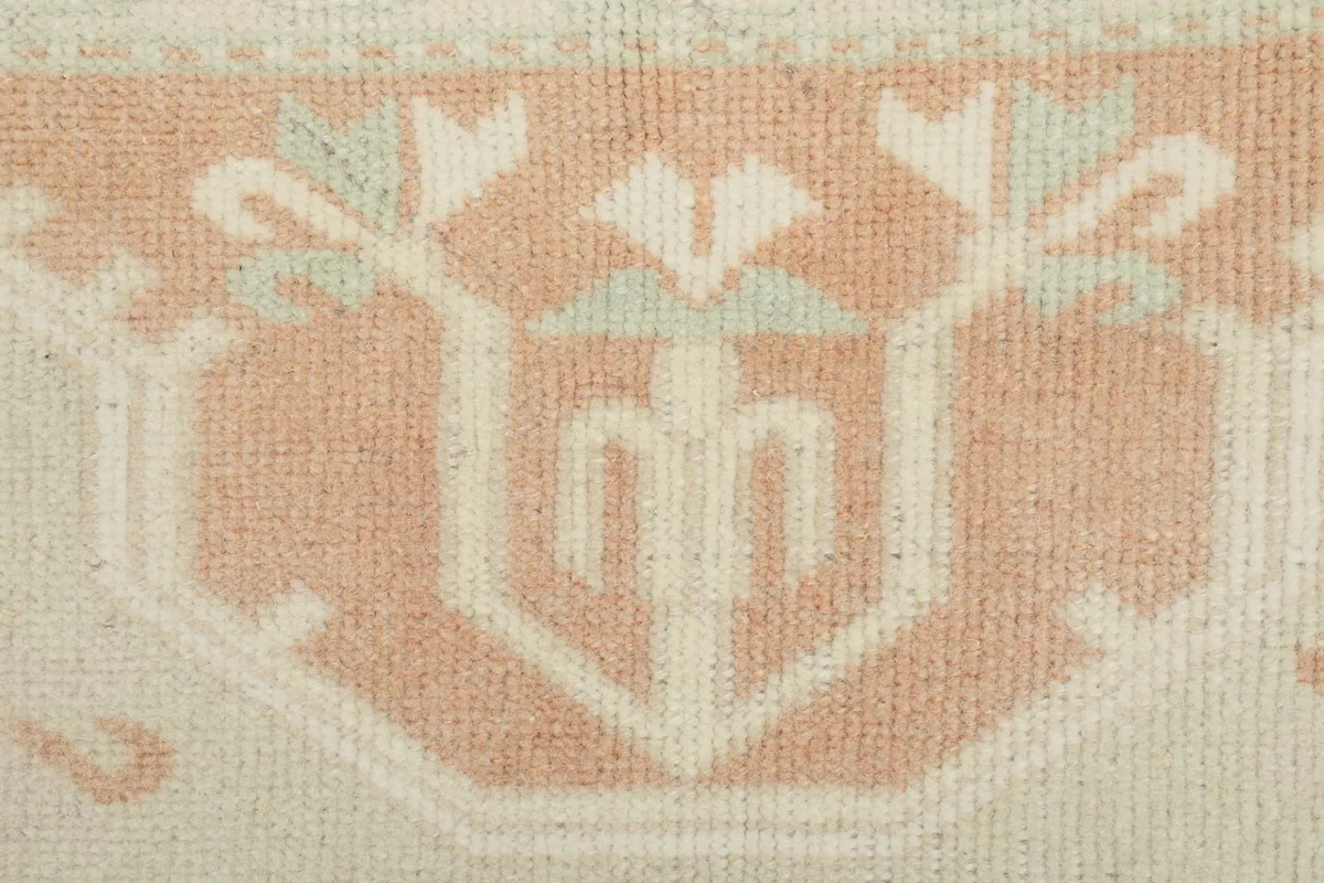 Close-up of a tribal floral-like motif within the rug's pattern
