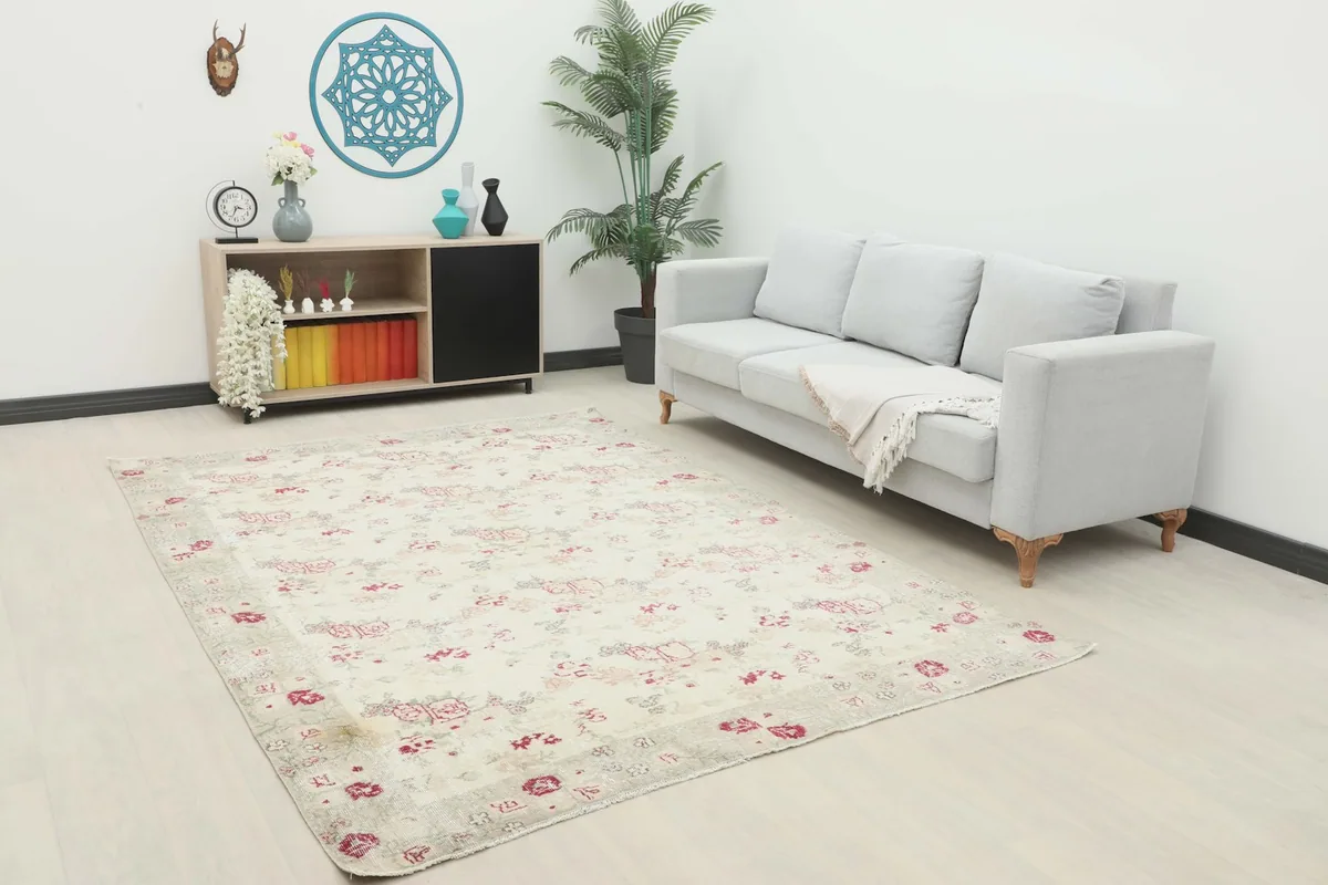 Vintage Anatolian rug displayed in a living room setting with a light gray sofa