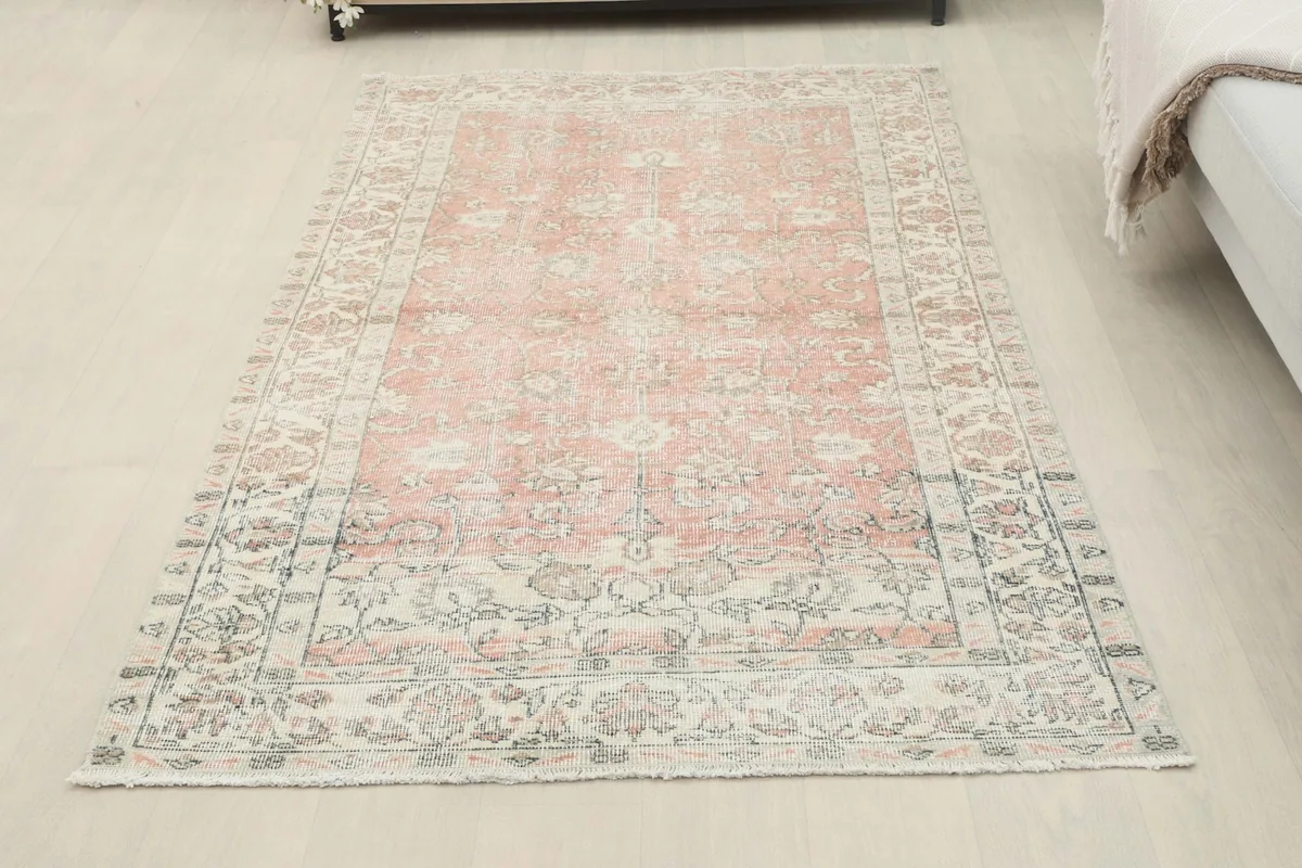 Full view of the small area rug placed in a bedroom setting next to a bed