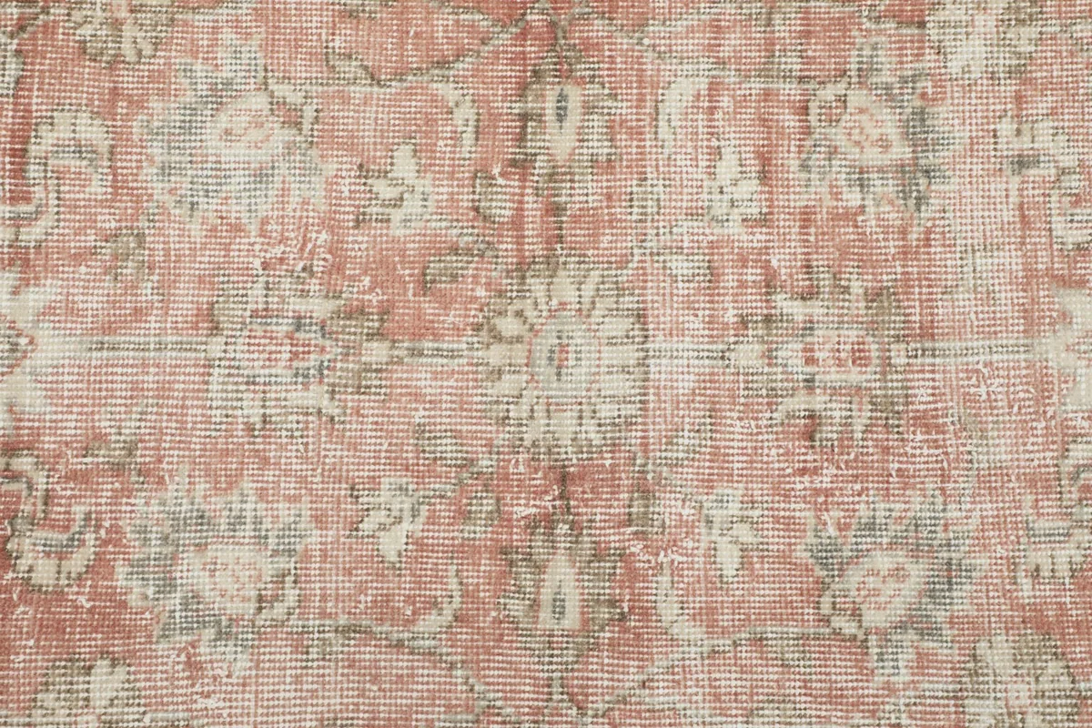 Close-up of the low wool pile, showing the texture and faded colors of the hand-knotted surface