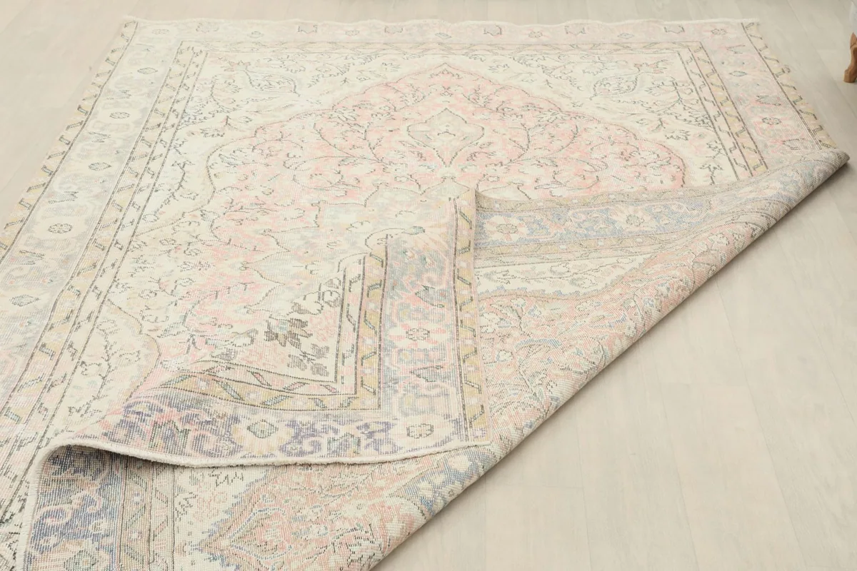 Partially folded rug showing the reverse side and the quality of the wool pile.