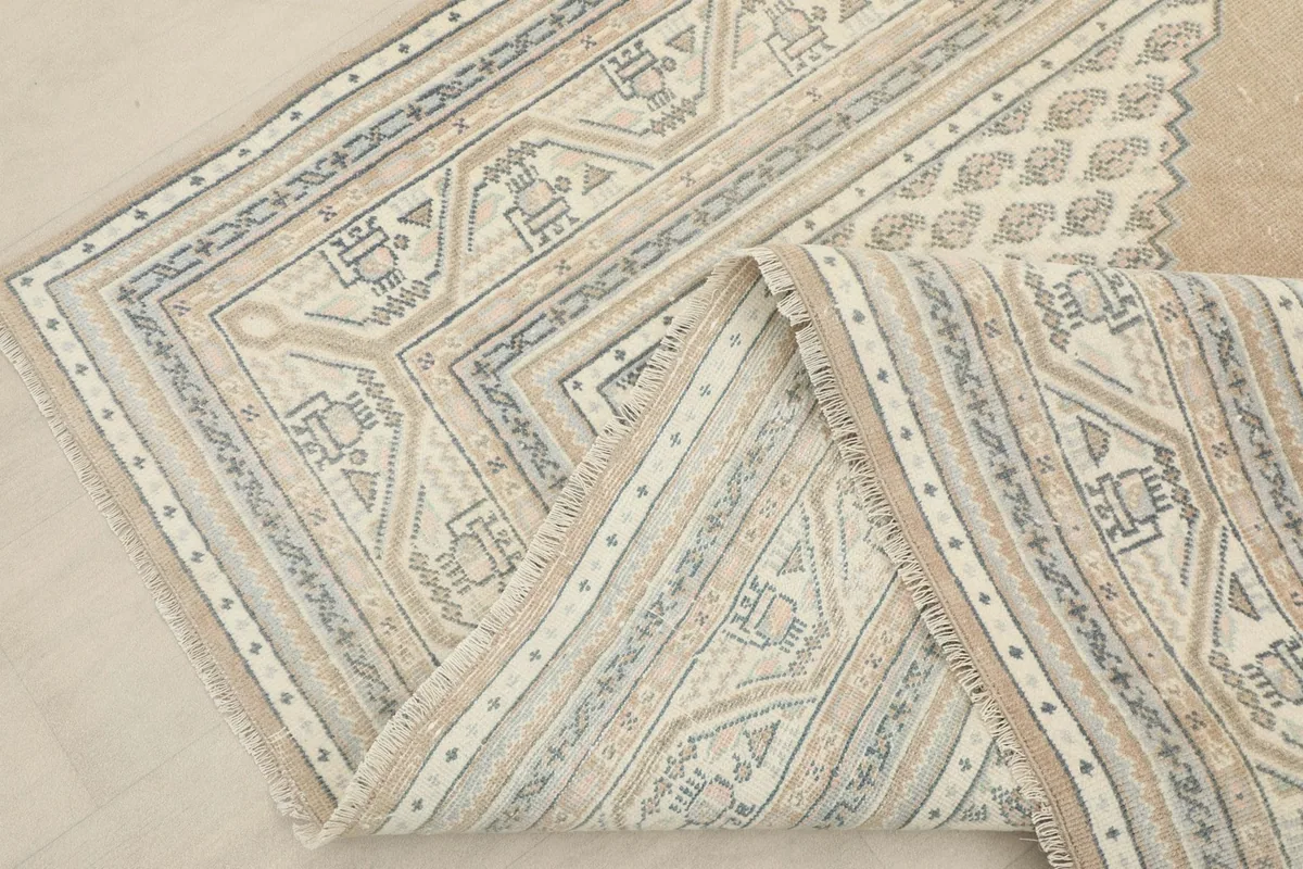View of the rug folded to show the flexibility and construction of the hand-knotted wool