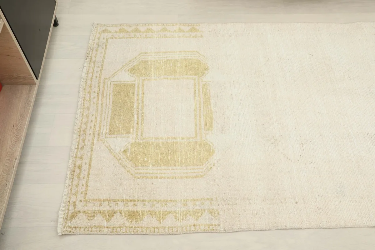 Close-up of the subtle gold geometric pattern and border at the other end of the hand-knotted runner.