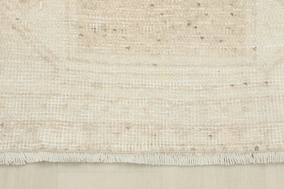 Close-up of the short, natural fringe and the woven edge of the vintage Anatolian runner rug.
